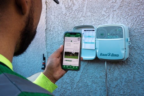 Personne qui programme le programmateur d'arrosage RC2 Rainbird avec l'application Rain Bird 2.0